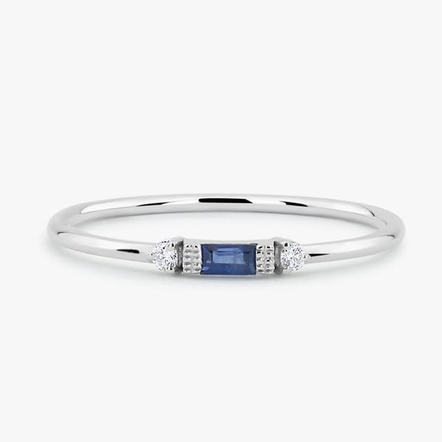 White gold ring with blue sapphire baguette and diamond accents