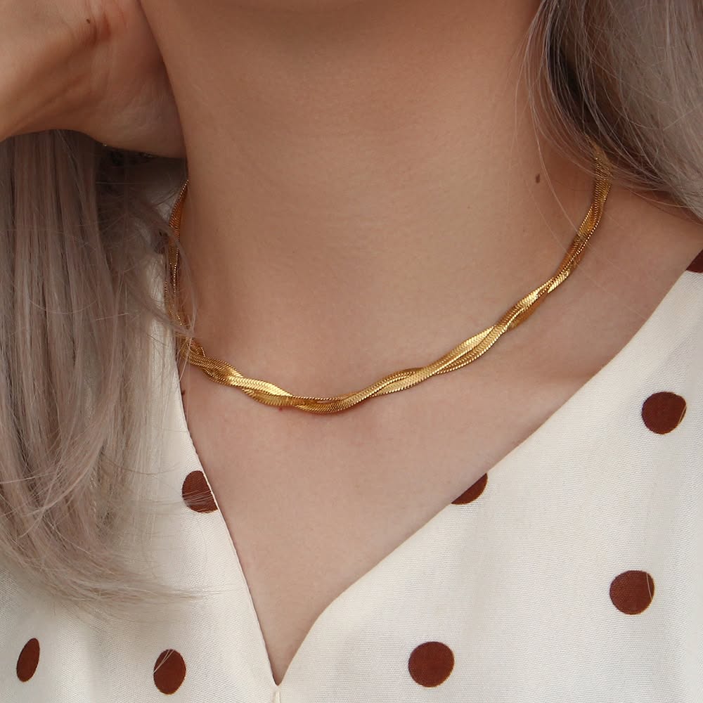 Gold herringbone chain necklace worn on model
