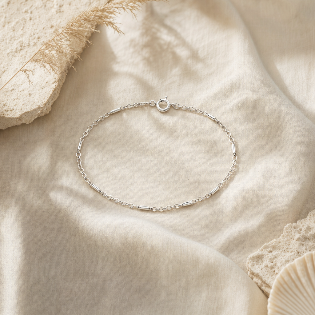 Sterling silver bar-and-chain bracelet on linen