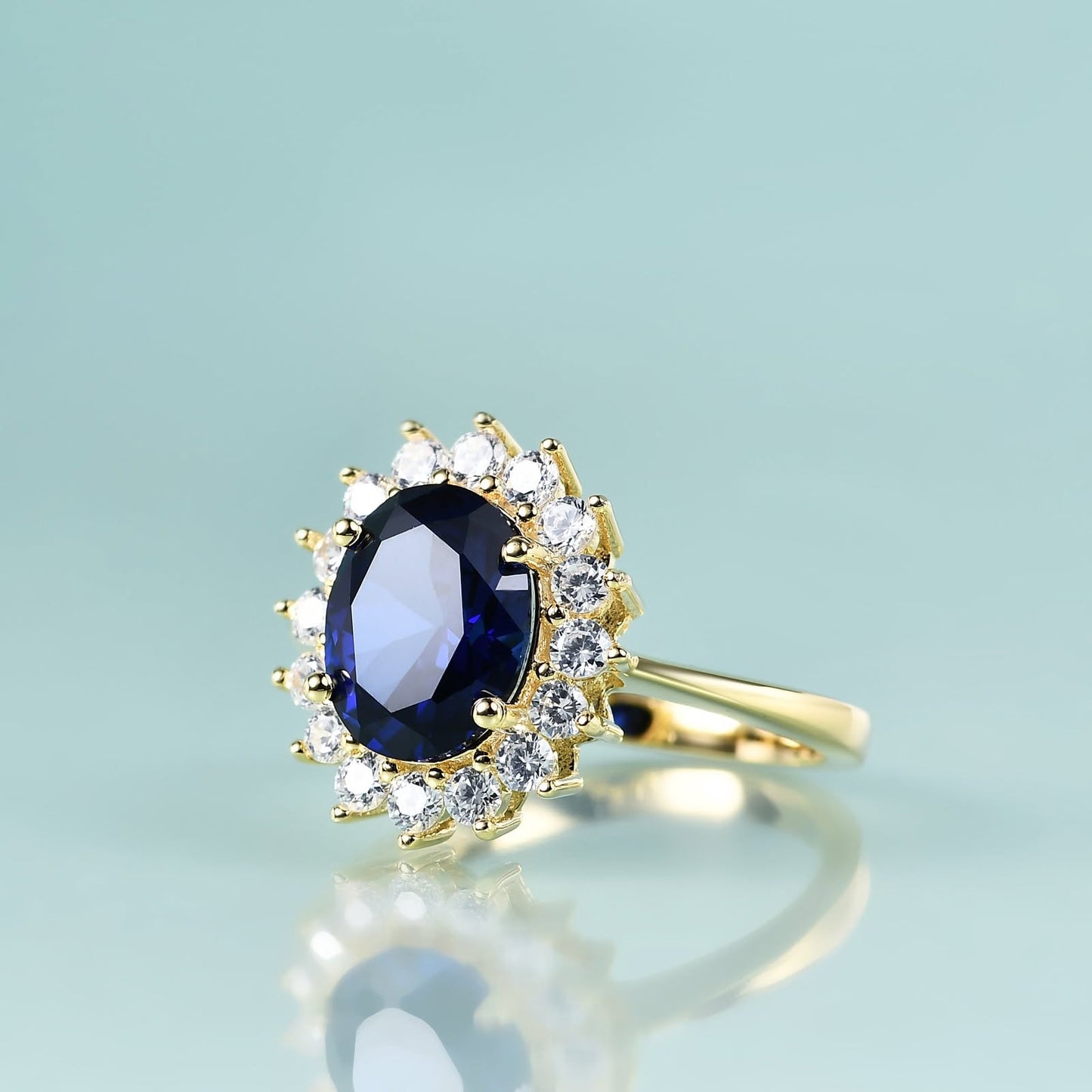 Yellow gold ring with blue sapphire halo