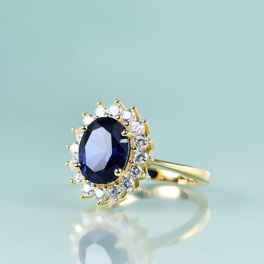Yellow gold ring with blue sapphire halo