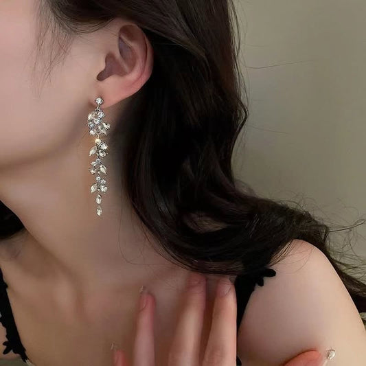 Crystal leaf drop earrings worn on model