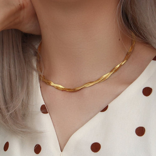 Gold herringbone chain necklace worn on model